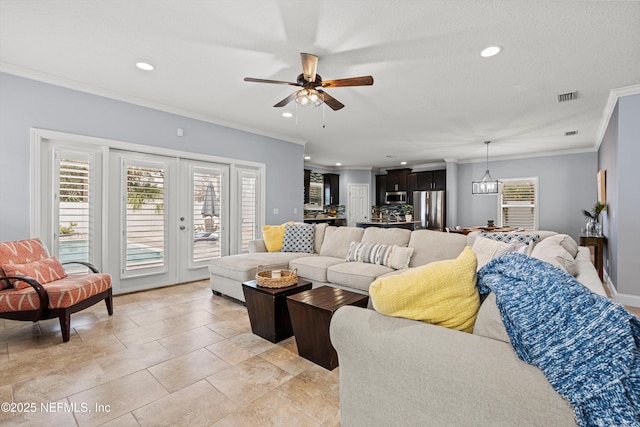 living room with a ceiling fan, visible vents, crown molding, and recessed lighting