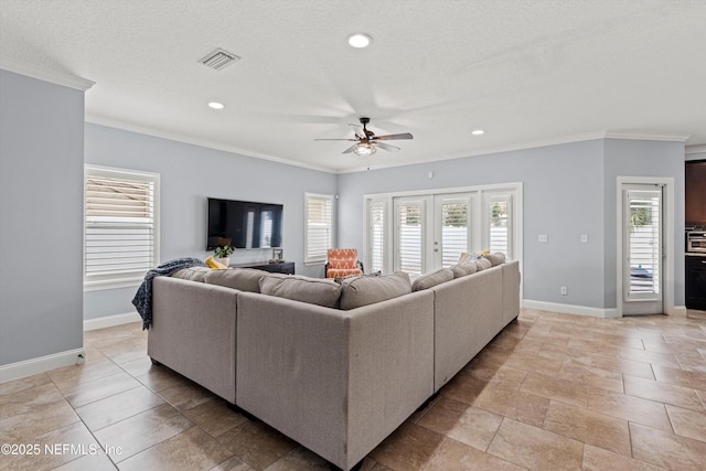 living area featuring ornamental molding, visible vents, and baseboards