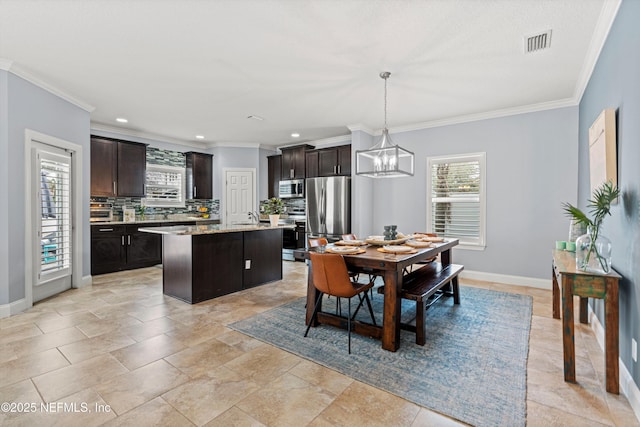 dining room featuring ornamental molding, recessed lighting, visible vents, and baseboards