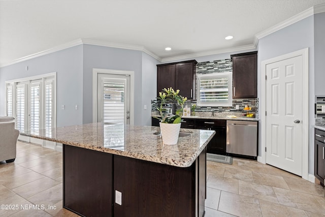 kitchen with dark brown cabinetry, a kitchen island, light stone counters, and dishwasher