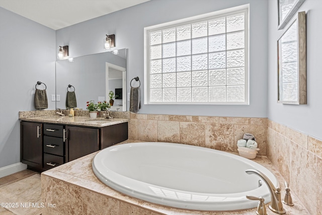 bathroom with a bath, vanity, and tile patterned floors