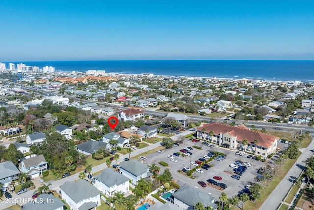 drone / aerial view with a residential view and a water view