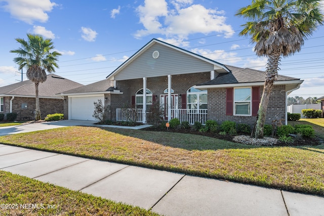 view of front of home featuring a porch, a garage, brick siding, driveway, and a front yard