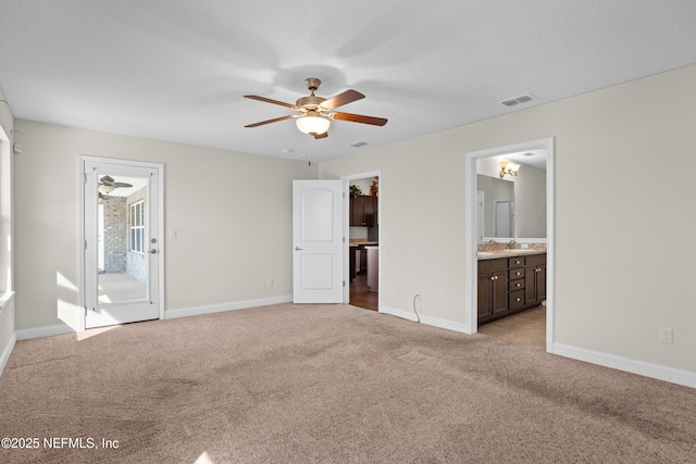 unfurnished bedroom featuring light carpet, baseboards, visible vents, and ensuite bathroom