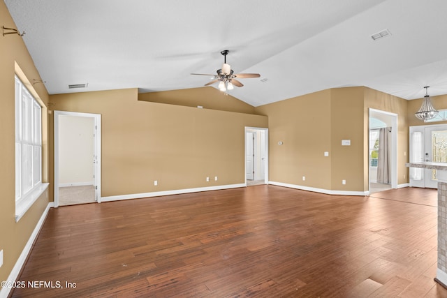 unfurnished living room featuring lofted ceiling, baseboards, visible vents, and wood finished floors