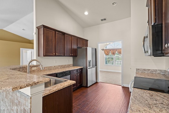 kitchen featuring dark brown cabinetry, a sink, visible vents, appliances with stainless steel finishes, and dark wood-style floors