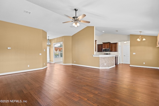 unfurnished living room featuring dark wood-style floors, visible vents, vaulted ceiling, and ceiling fan with notable chandelier