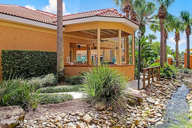 exterior space featuring ceiling fan