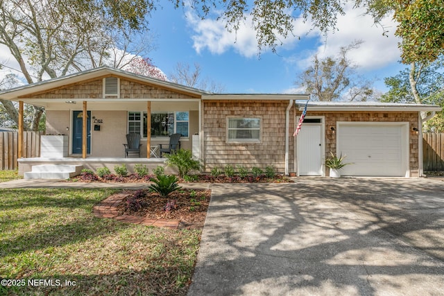 view of front of property with a garage, aphalt driveway, and a porch