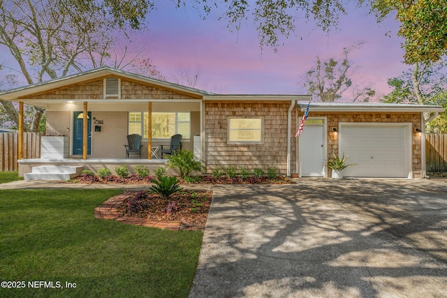 view of front facade featuring an attached garage, covered porch, fence, and aphalt driveway