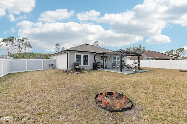 rear view of house featuring a pergola, a lawn, a patio, and an outdoor fire pit