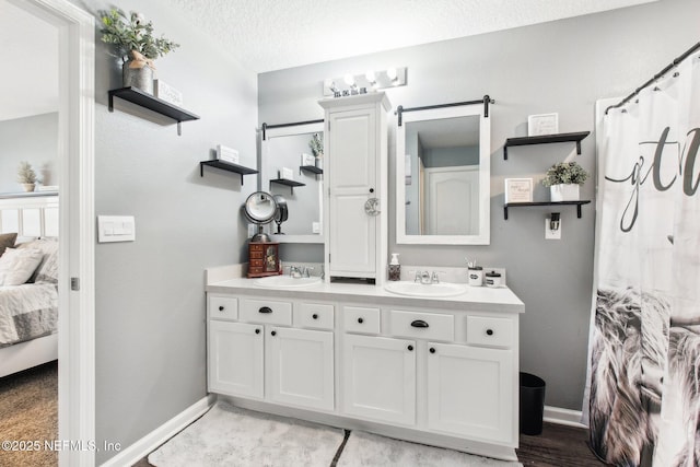 bathroom with vanity and a textured ceiling