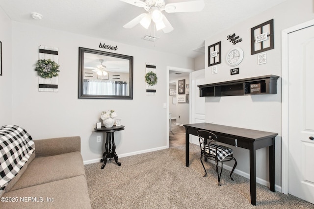 carpeted office featuring ceiling fan