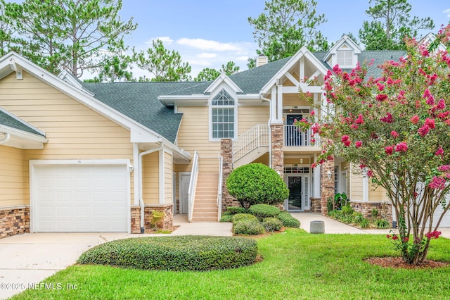 craftsman house featuring a garage and a front lawn