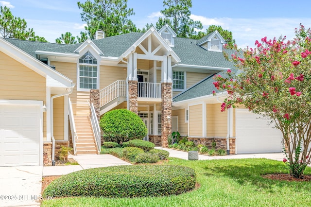 craftsman inspired home featuring a garage and a front yard