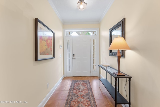 tiled entryway featuring crown molding