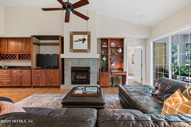 living room with light tile patterned floors, a fireplace, and high vaulted ceiling