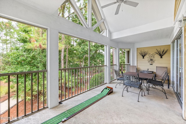 sunroom featuring ceiling fan and lofted ceiling