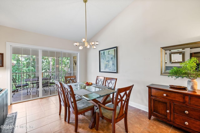 dining room featuring high vaulted ceiling, light tile patterned floors, and an inviting chandelier