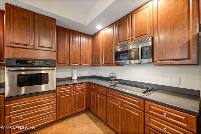 kitchen with light tile patterned flooring and appliances with stainless steel finishes