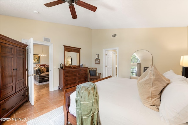 tiled bedroom featuring vaulted ceiling and ceiling fan