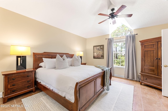 bedroom featuring ceiling fan, lofted ceiling, a textured ceiling, and light tile patterned floors