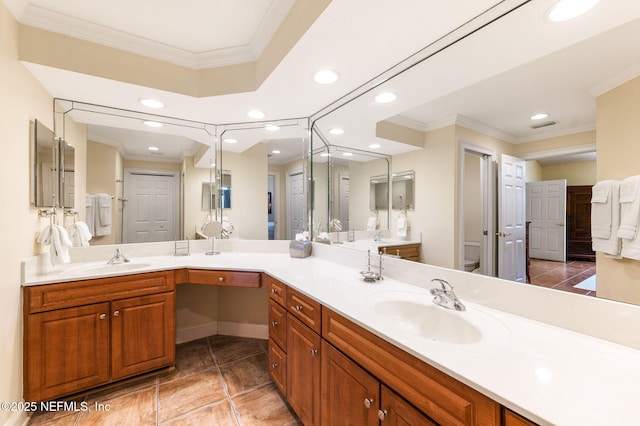 bathroom featuring crown molding, vanity, and toilet