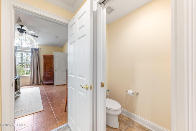 bathroom featuring ceiling fan, vaulted ceiling, tile patterned floors, and toilet