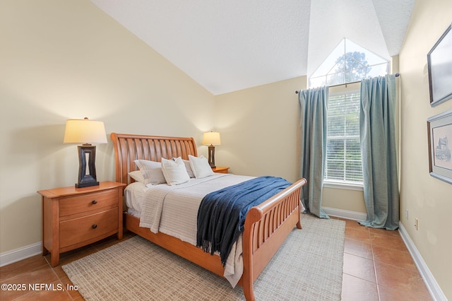 bedroom featuring vaulted ceiling and light tile patterned floors