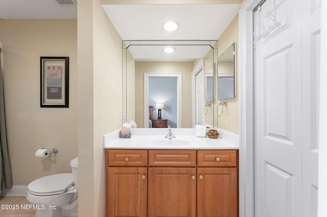 bathroom with tile patterned floors, toilet, and vanity