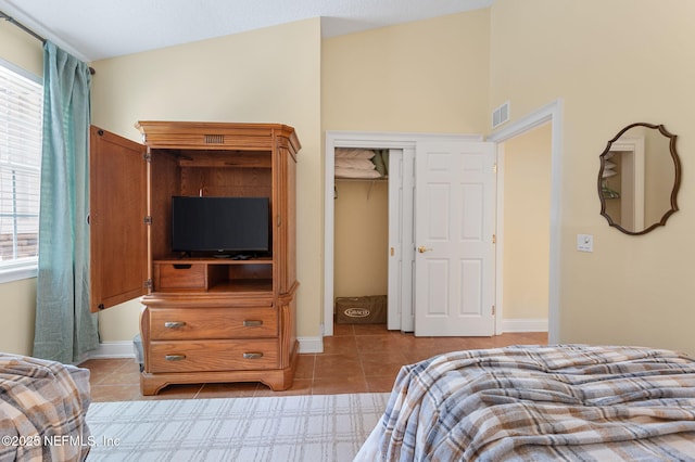 bedroom with a closet and light tile patterned floors