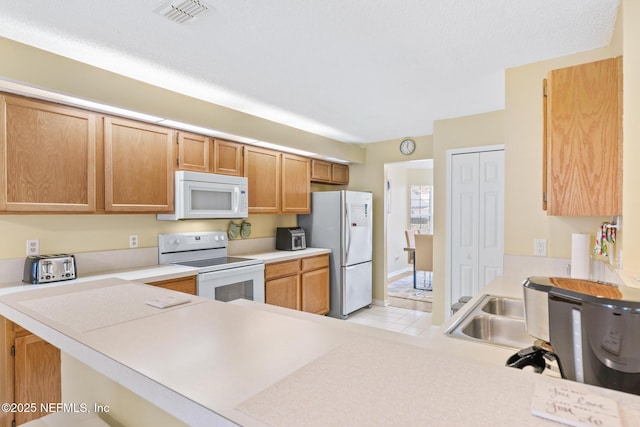 kitchen with white appliances and kitchen peninsula