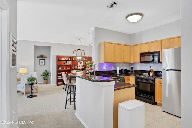 10961 Burnt Mill Rd Unit 425, Jacksonville, FL 32256 - kitchen with light brown cabinetry, a kitchen breakfast bar, kitchen peninsula, pendant lighting, and black appliances