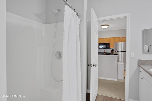 10961 Burnt Mill Rd Unit 425, Jacksonville, FL 32256 - bathroom with vanity, a shower with curtain, and hardwood / wood-style flooring
