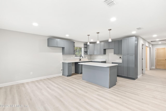 kitchen with a center island, visible vents, and gray cabinetry