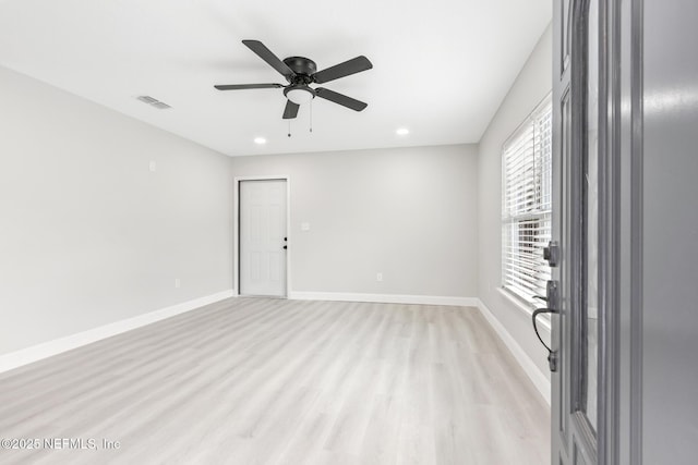 spare room with recessed lighting, a ceiling fan, visible vents, baseboards, and light wood-type flooring