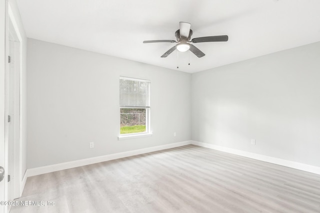 unfurnished room with light wood finished floors, baseboards, and a ceiling fan