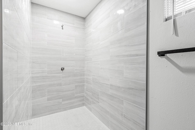 bathroom with a tile shower