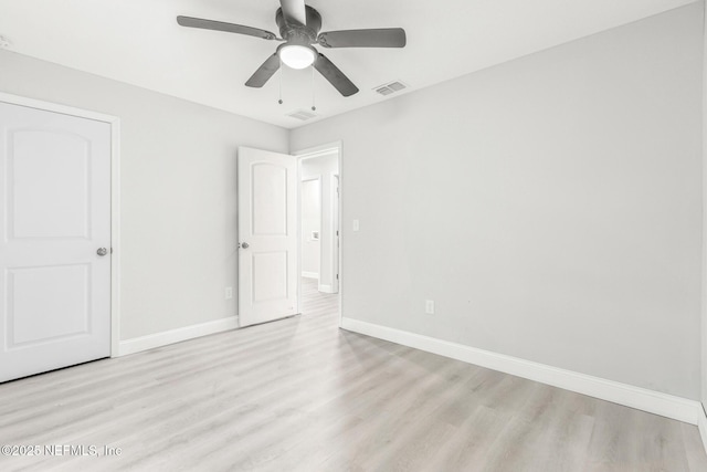 unfurnished bedroom with a ceiling fan, wood finished floors, visible vents, and baseboards