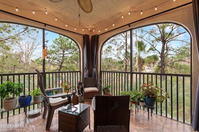 sunroom with ceiling fan and a healthy amount of sunlight