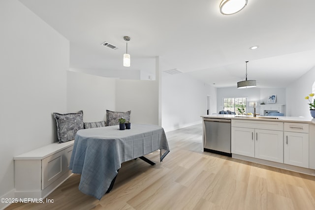 dining room featuring light wood-type flooring, visible vents, and recessed lighting