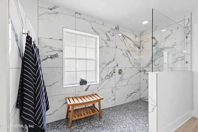 full bathroom featuring recessed lighting and a marble finish shower