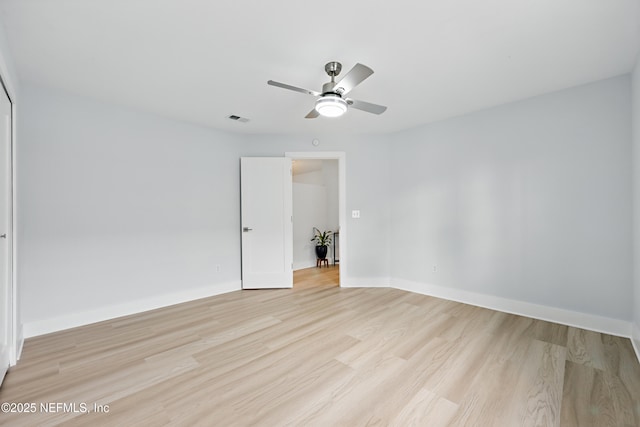 unfurnished room with light wood-type flooring, baseboards, and visible vents