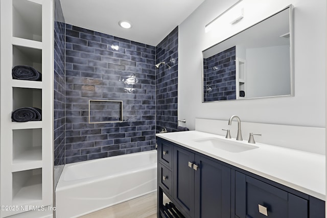 full bath with shower / tub combination, visible vents, wood finished floors, and vanity