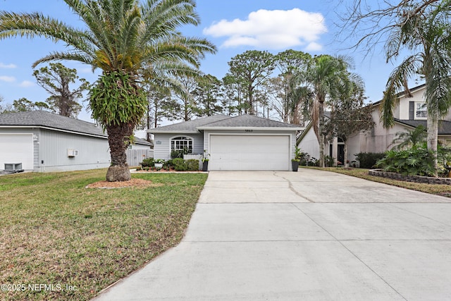 view of front of property with a front yard, concrete driveway, and an attached garage