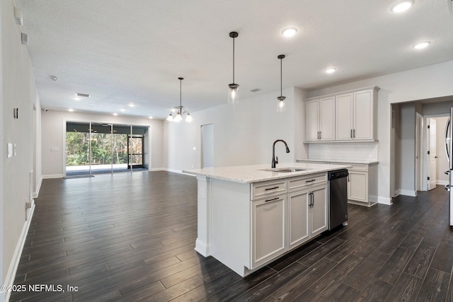 kitchen with dishwasher, an island with sink, white cabinets, decorative light fixtures, and sink