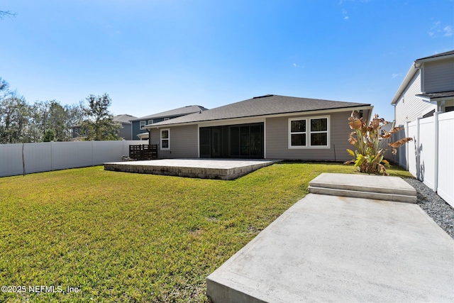 rear view of house featuring a yard and a patio area