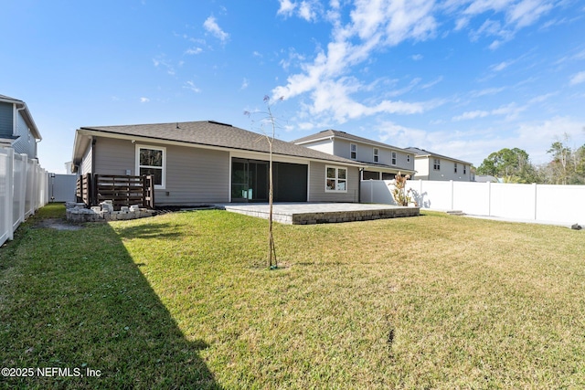 rear view of house featuring a yard and a patio area