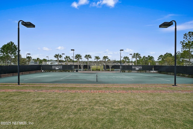 view of tennis court with a lawn