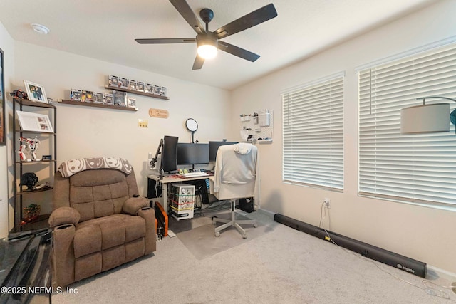 carpeted office featuring ceiling fan